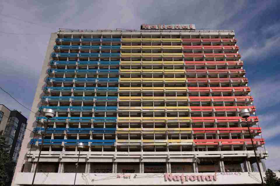 Abandoned National Hotel in Chisinau, Moldova, painted with the colors of the Moldovan flag.