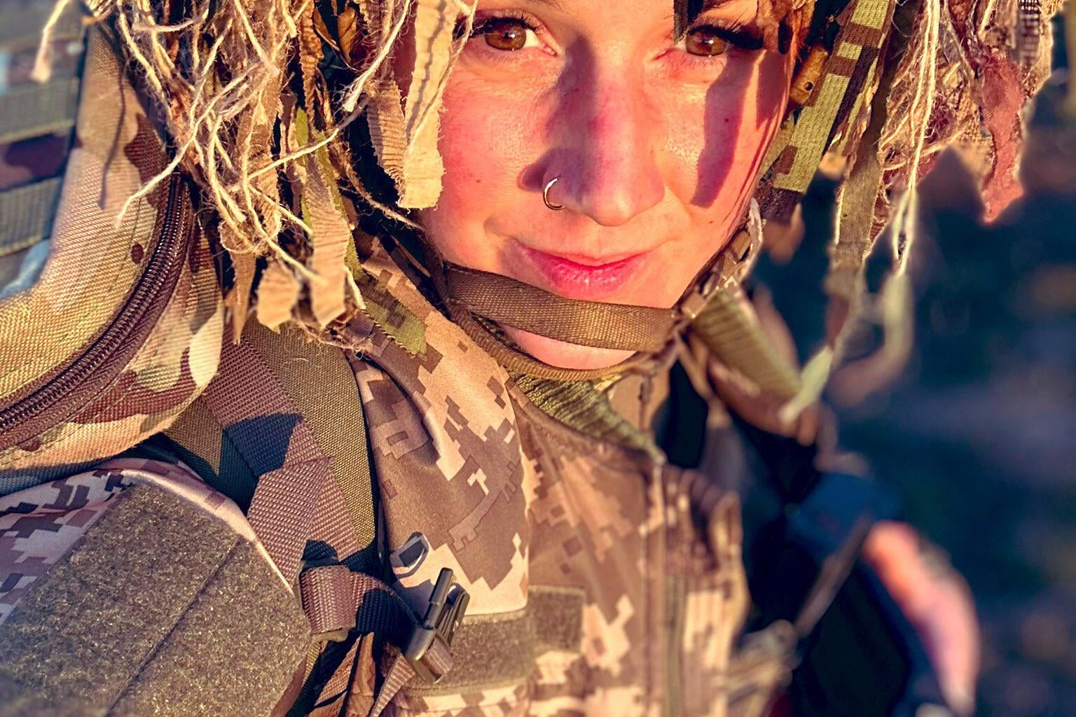 Ukrainian soldier with camouflage on her helmet - she is from the 93rd Brigade Special Rifle Battalion - within the 93rd Separate Mechanized Brigade Kholodnyi Yar - of the Ukrainian Army.