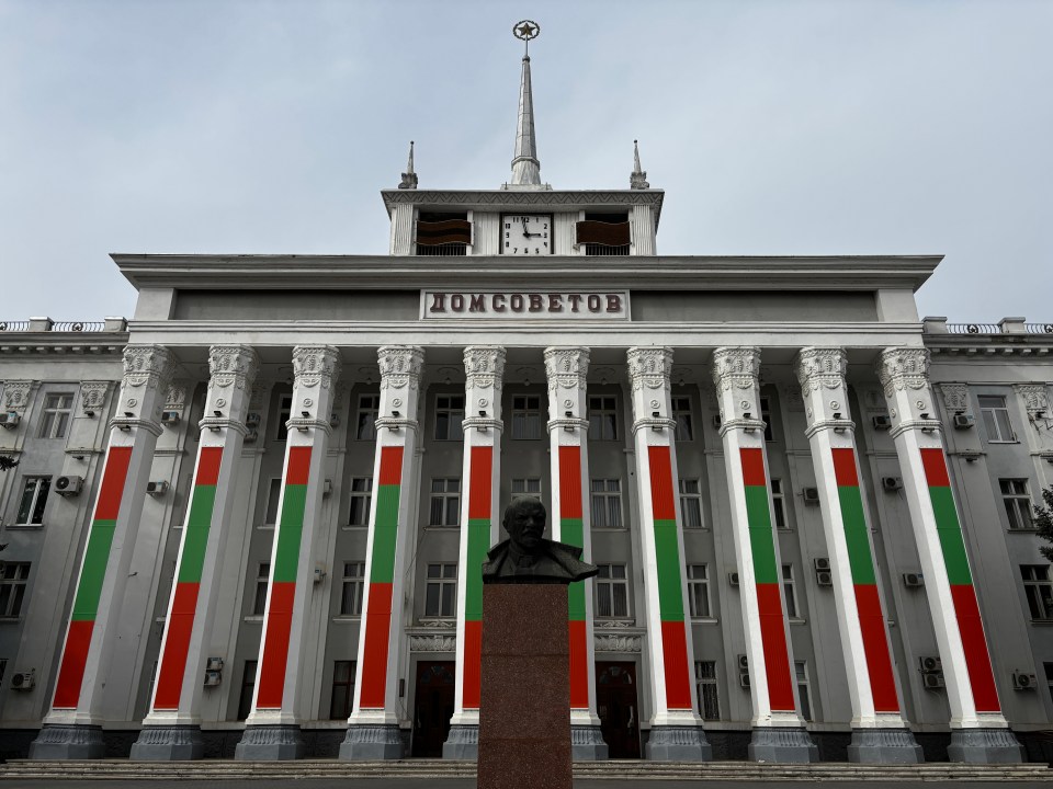 Transnistria parliament building in Tiraspol with a bust in front.