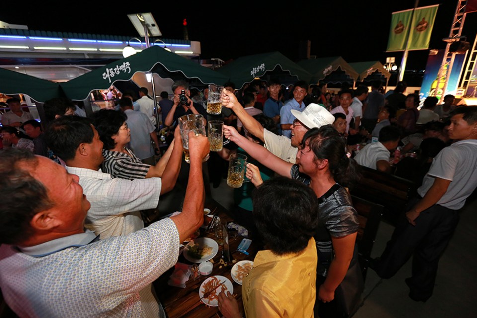 People toasting beer at a North Korean beer festival.
