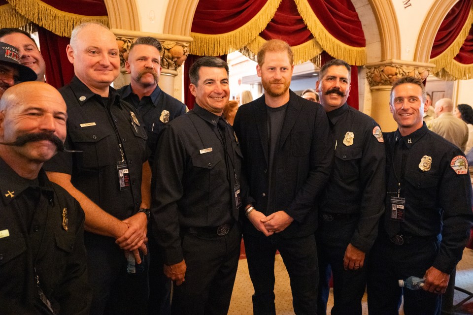 Prince Harry with firefighters at a benefit event.