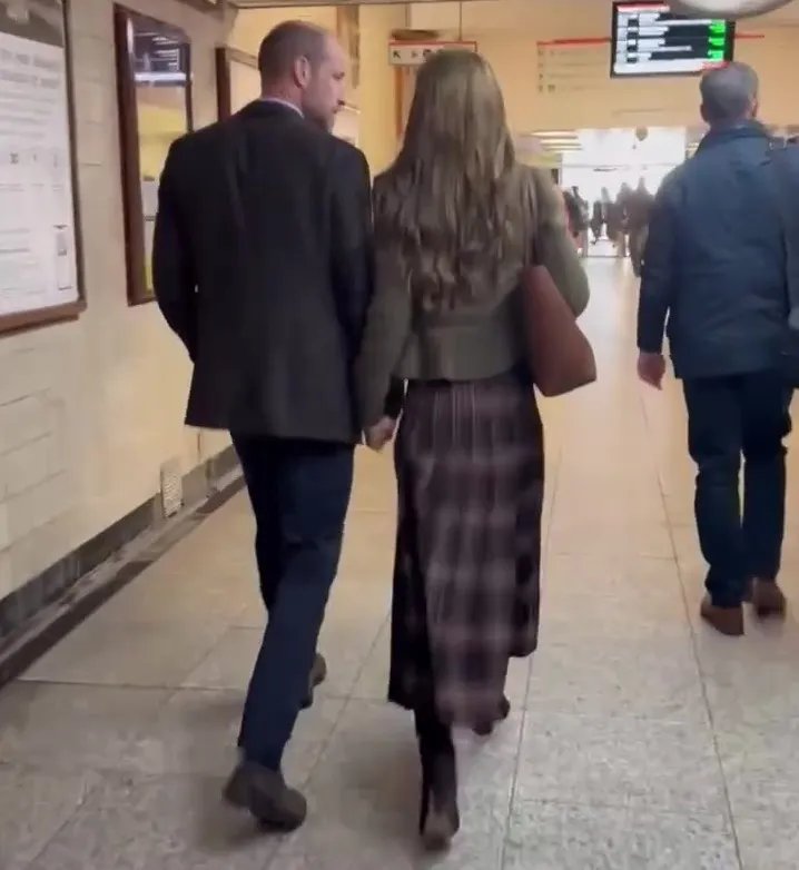 The Prince and Princess of Wales holding hands and walking away.