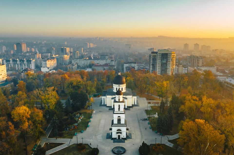 an aerial view of a city with a church in the foreground