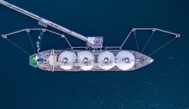 Aerial of Liquified Natural Gas LNG carrier moored to a small gas terminal