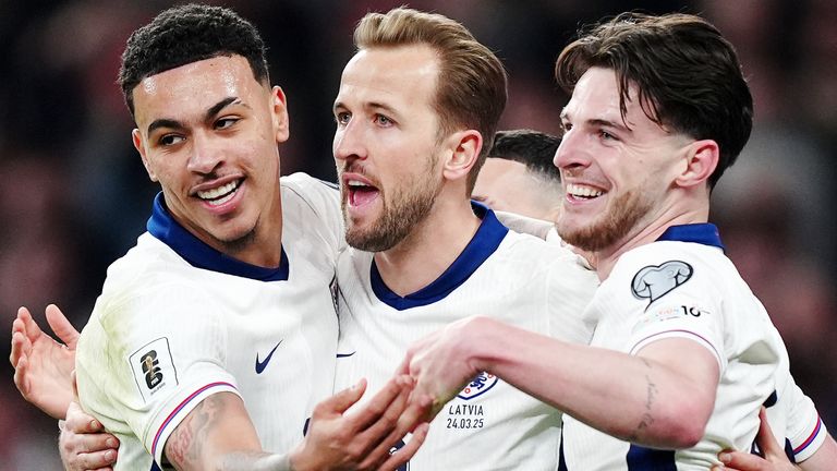 Morgan Rogers and Declan Rice celebrate with Harry Kane after he scored England's second goal against Latvia