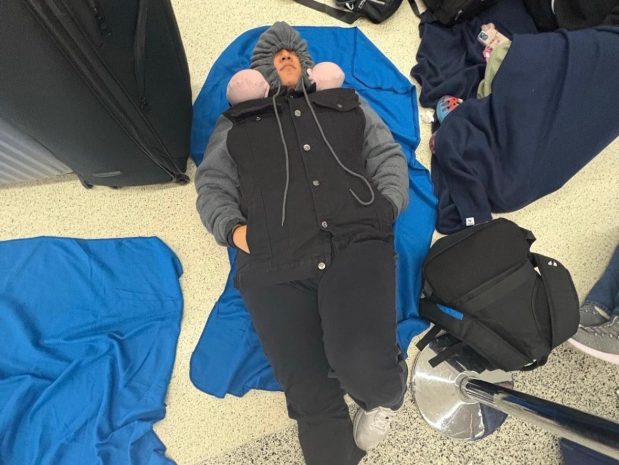 Students from Coral Springs Charter School slept on the floor at Miami International Airport Friday morning, March 21, 2025, after their flight to Athens, Greece, was canceled due to fires at Heathrow International Airport in London, where they were to have a layover. The students were unable to get on another flight that go them to Greece in time to make it on a cruise scheduled for Monday. (Allyson Dudich / Courtesy)