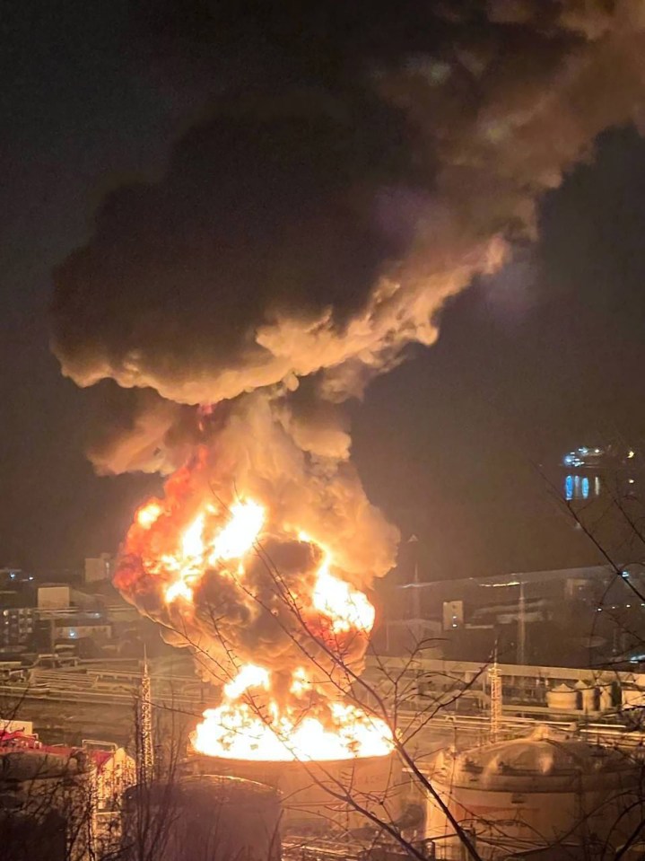 Large fire engulfing an oil refinery.