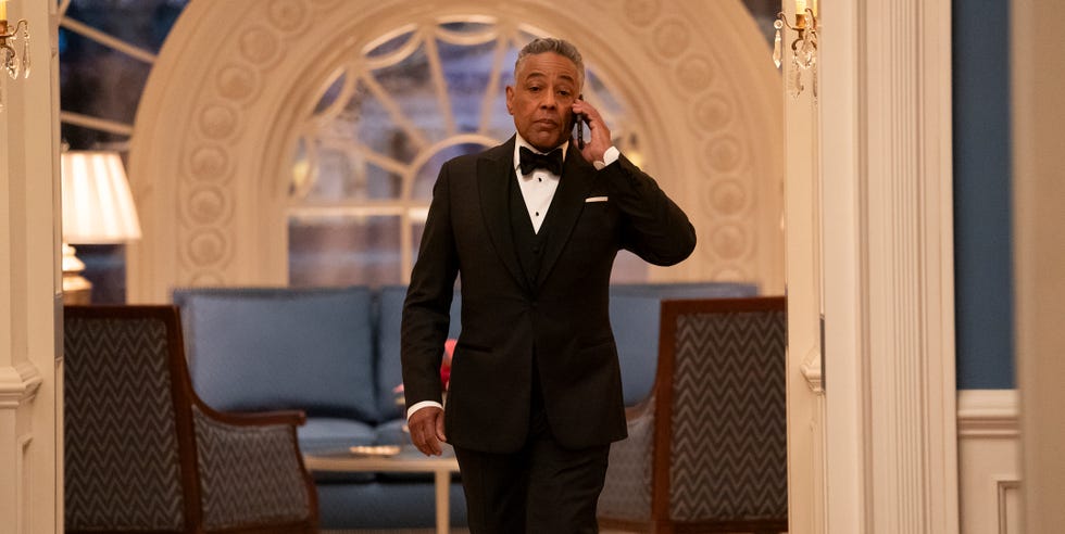 a man in formal attire engaged in a phone conversation in an elegantly decorated environment