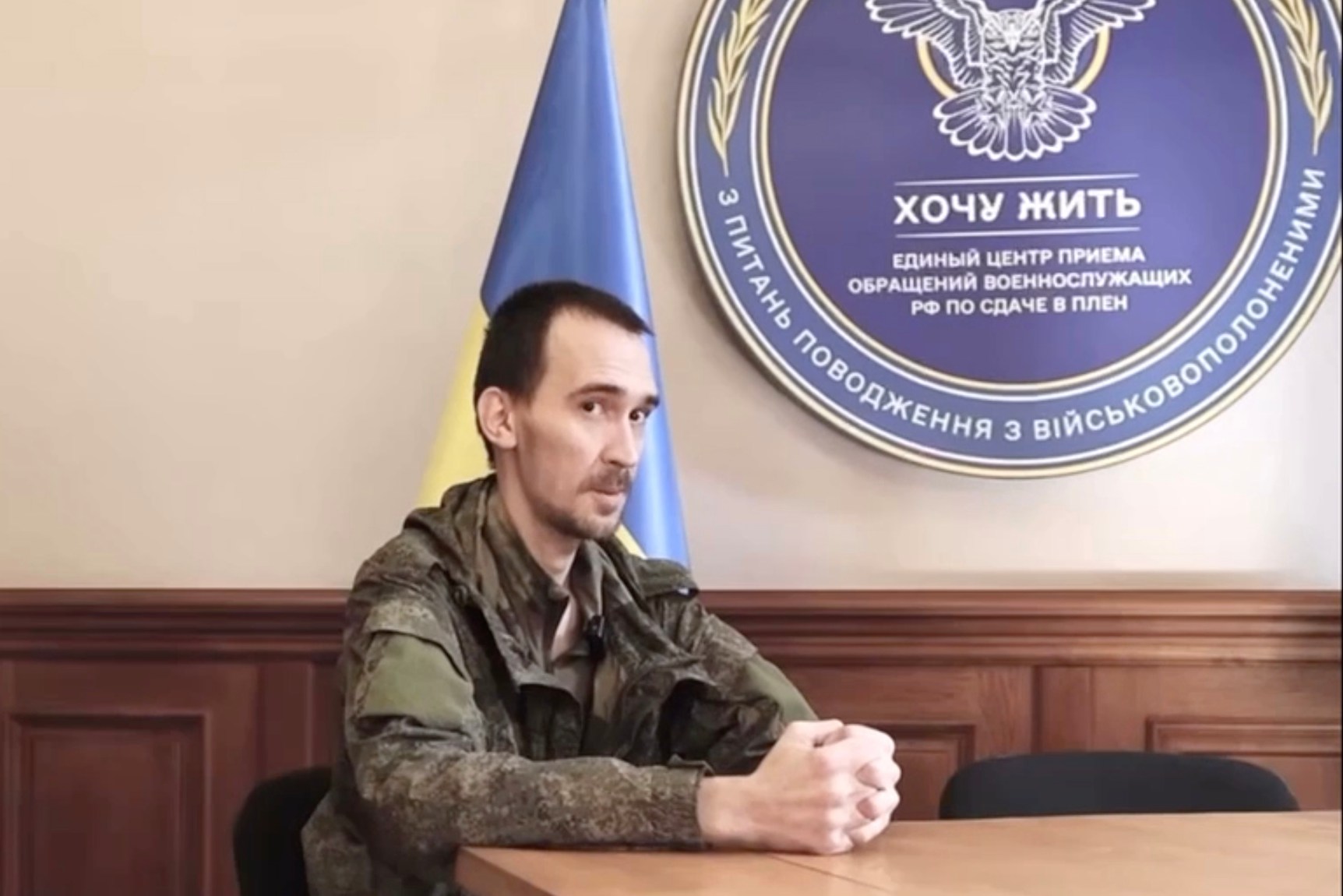 A prisoner of war sits at a table in Kyiv.