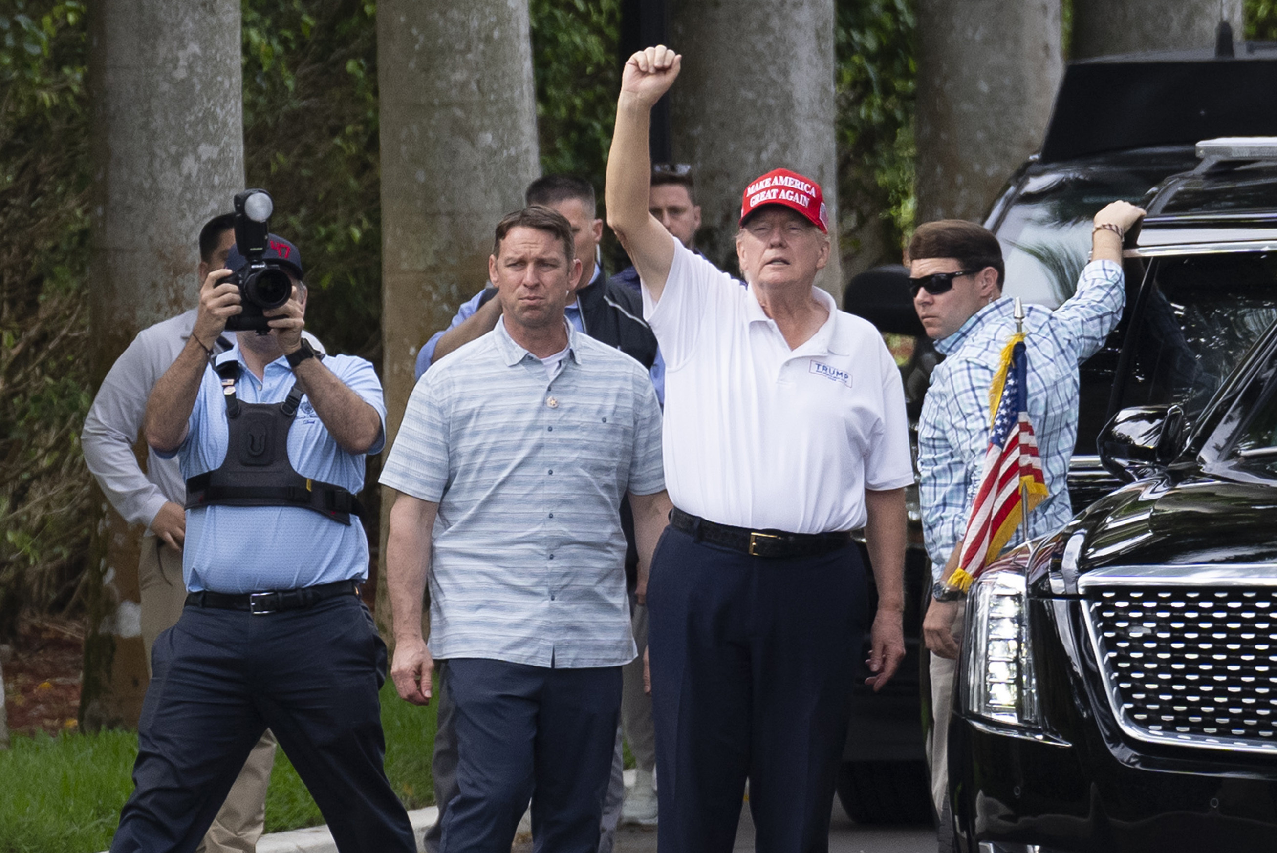 President Trump gestures to supporters while leaving a rally.