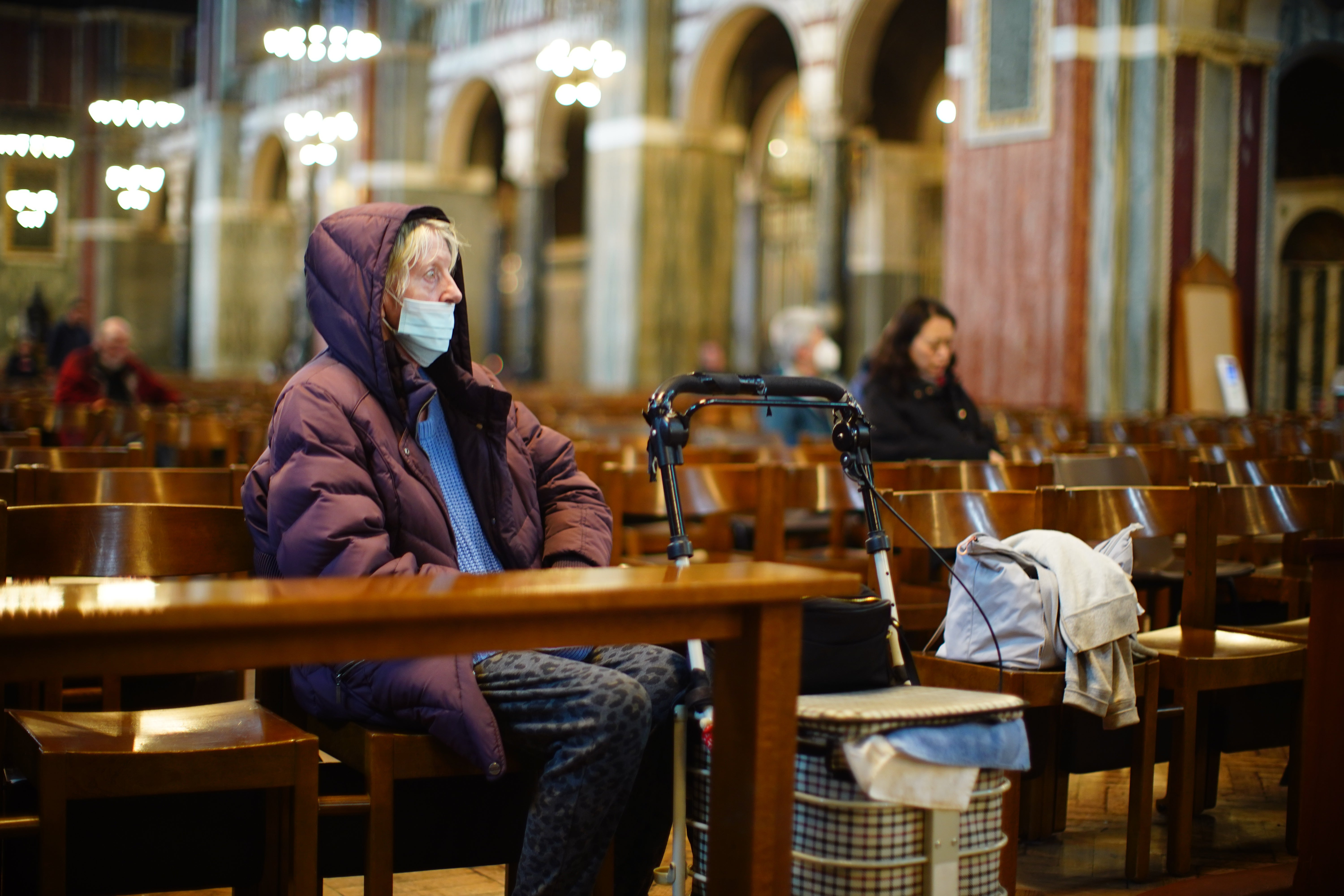 People sit in Westminster Cathedral in Victoria, London, following the announcement by the Vatican of the death of Pope Francis.