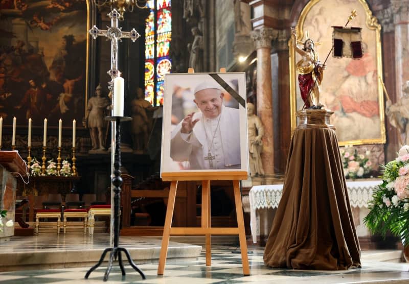 A picture of Pope Francis is displayed inside St. Stephen's Cathedral in Vienna, where people gather to attend a mass following the announcement of his death. The Argentine pontiff, who led the Catholic Church since 2013, passed away on April 21, 2025, at the age of 88, leaving a lasting legacy among millions of faithful around the world. Tobias Steinmaurer/APA/dpa