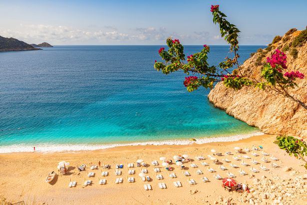 Kaputas beach in Antalya region, Turkey with clear turquoise water, sun umbrellas and sandy beach. Holiday or vacation resort