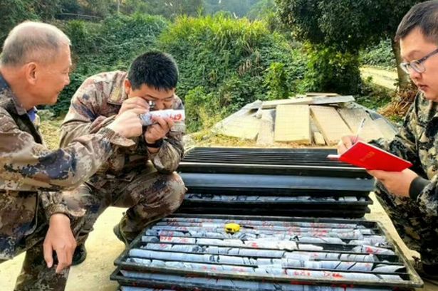 People inspecting gold at a deposit