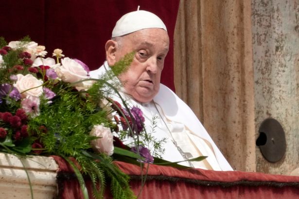 Pope Francis appears on the central lodge of St. Peter's Basilica to bestow the Urbi et Orbi