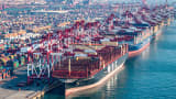 Cargo ships and containers at Qingdao port in eastern China's Shandong province on Dec. 4, 2024.