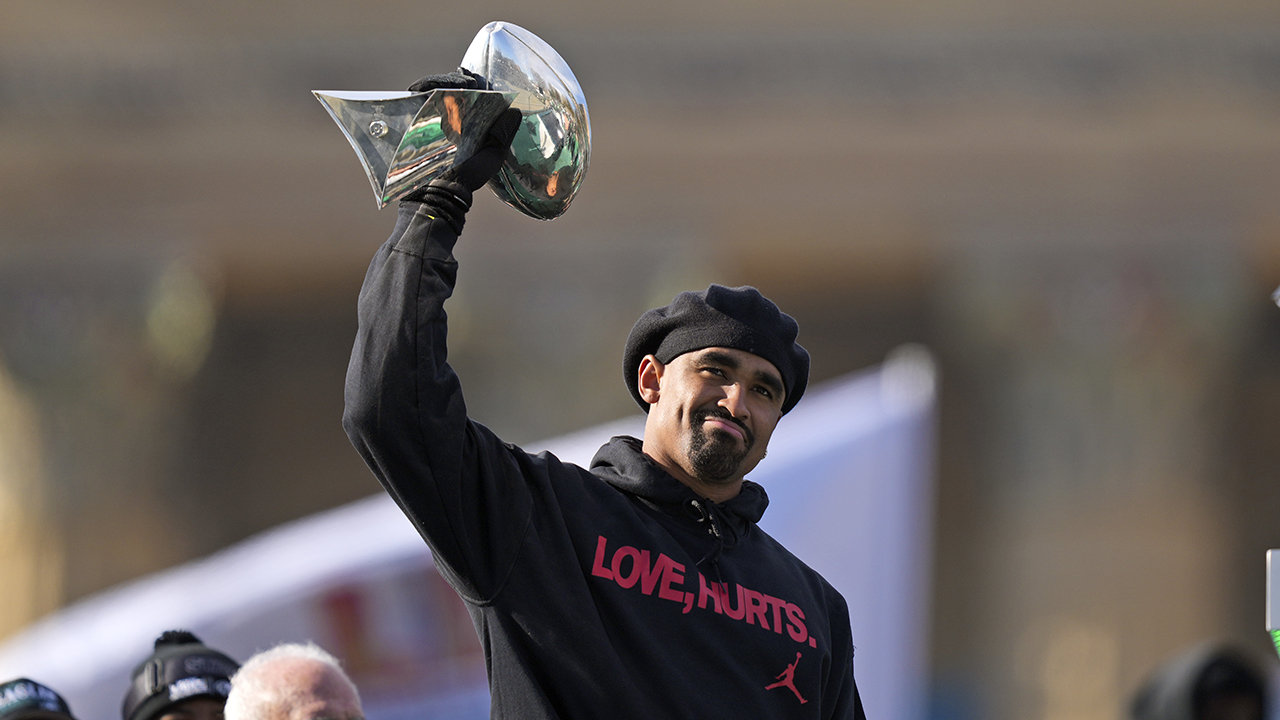 Philadelphia Eagles quarterback Jalen Hurts holds up the Lombardi trophy as he speaks during the team's NFL football Super Bowl 59 parade and celebration, Friday, Feb. 14, 2025.