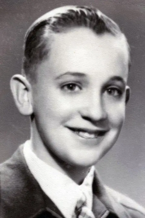 Family handout Jorge Mario Bergoglio is shown in a black and white school photo. He is smiling.
