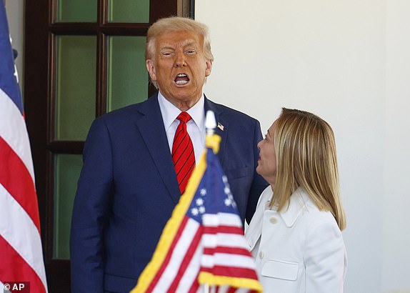 President Donald Trump, left, speaks as he greets Italy's Prime Minister Giorgia Meloni upon her arrival at the White House, Thursday, April 17, 2025, in Washington. (AP Photo/Tom Brenner)