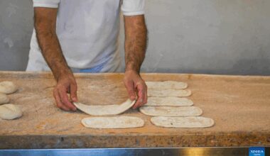 Cooks prepare pides at restaurant in Bursa, Türkiye-Xinhua