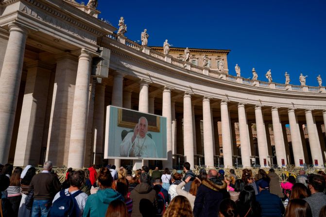Pope Francis appears on a giant monitor set up in the Vatican's St. Peter's Square in December 2023. Francis led his customary Angelus prayer from his home rather than from the window of the Vatican's Apostolic Palace overlooking the square. He was suffering from what he described as 