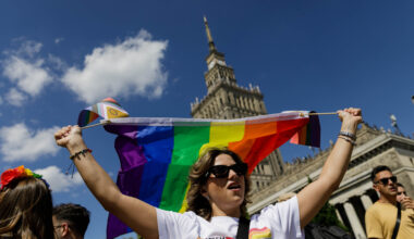 A participant holds a rainbow flag before the procession in Warsaw, Poland.