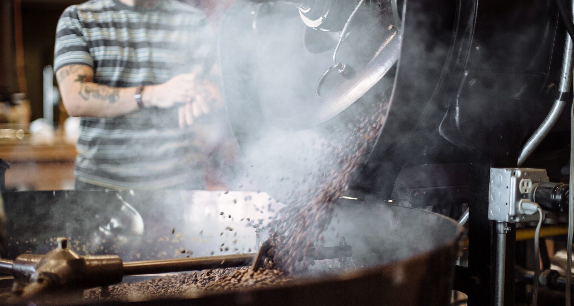 A Wonderstate Coffee worker operating a roaster