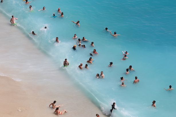 An aerial view of citizens and tourists spending time at Kaputas beach during the Eid holiday to cool off in Antalya, Turkiye
