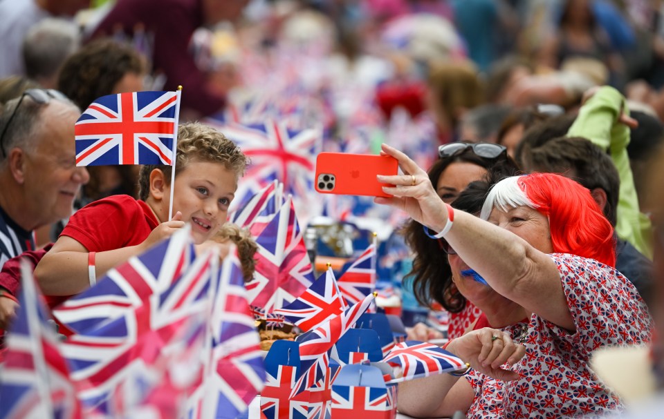 Woman taking a selfie at a Platinum Jubilee street party.