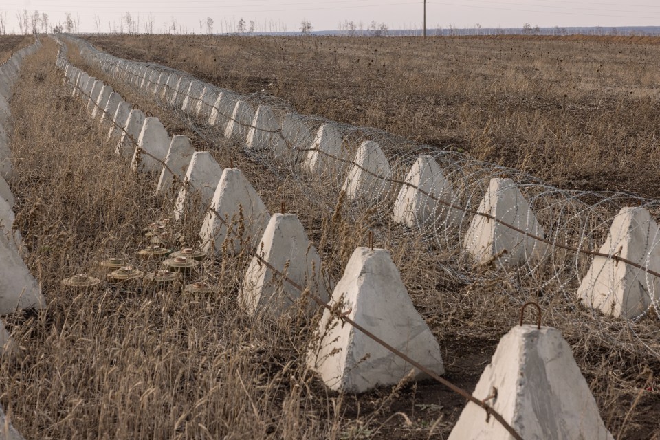 Anti-tank obstacles and barbed wire along a fortification line in the Kharkiv region of Ukraine.