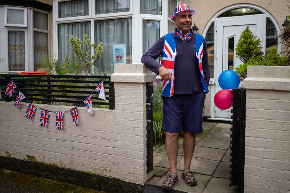 Man in Union Jack attire at a street party.