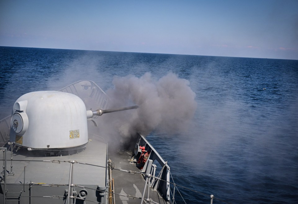 Romanian naval ship firing ammunition during a military drill.