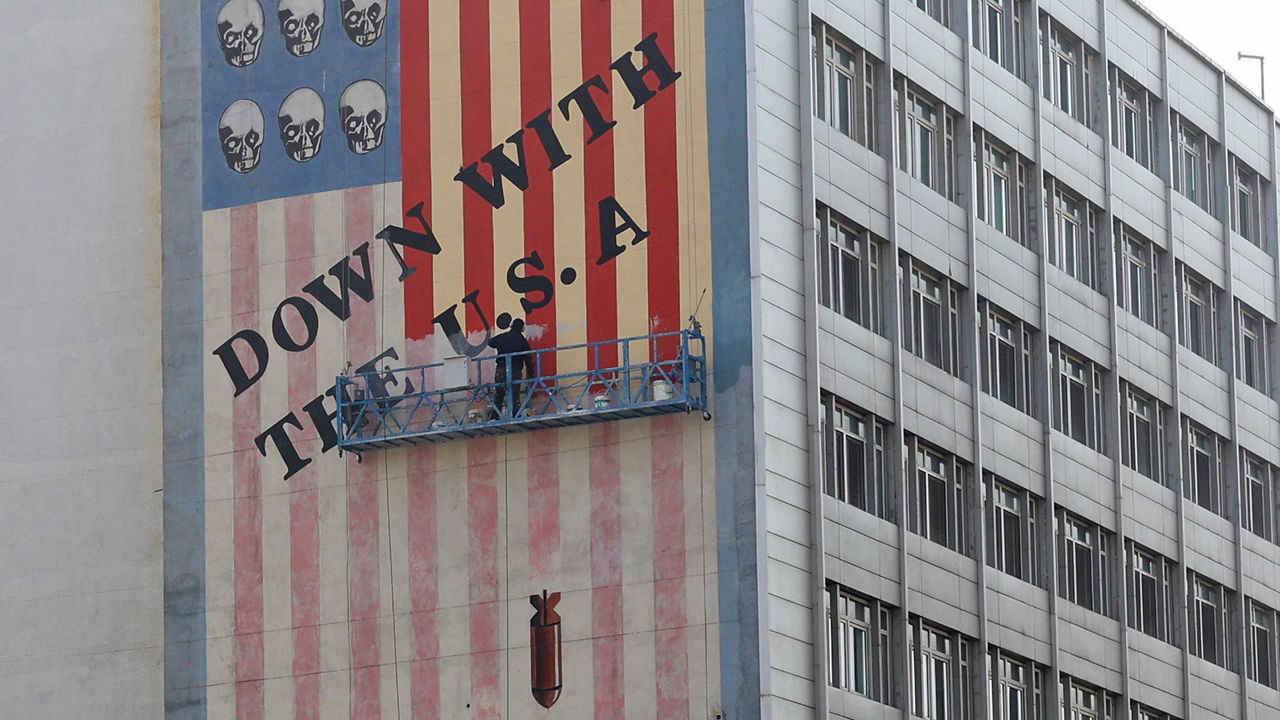 An Iranian painter repaints one of the famous anti-US murals in Tehran, Iran, 29 March 2025