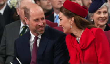Kate Middleton and Prince William laughing and turning to smile at each other
