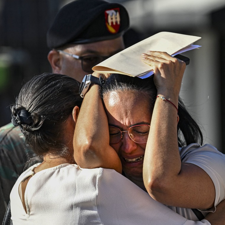 A woman cries outside of the Jet Set nightclub