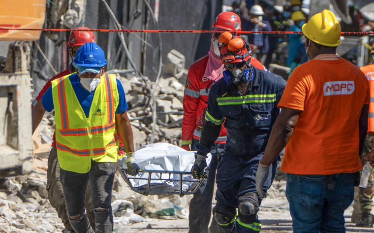 Rescue teams members carry a body from the Jet Set nightclub  
