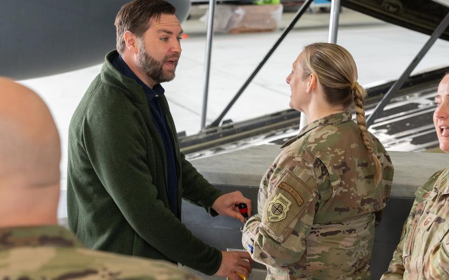 Vice President JD Vance pours beer for a service member