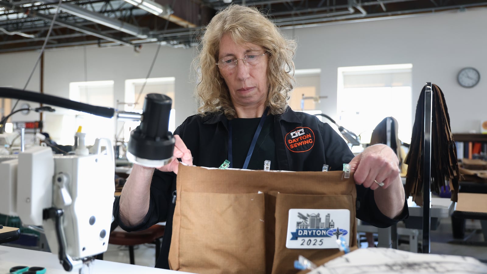 Debbie Bertke, a volunteer with Dayton Sewing Collaborative, looks over a gift bag that will be given to NATO Parliamentary Assembly Spring Session participants in May. The bags were unveiled during a news conference on Monday. BRYANT BILLING / STAFF
