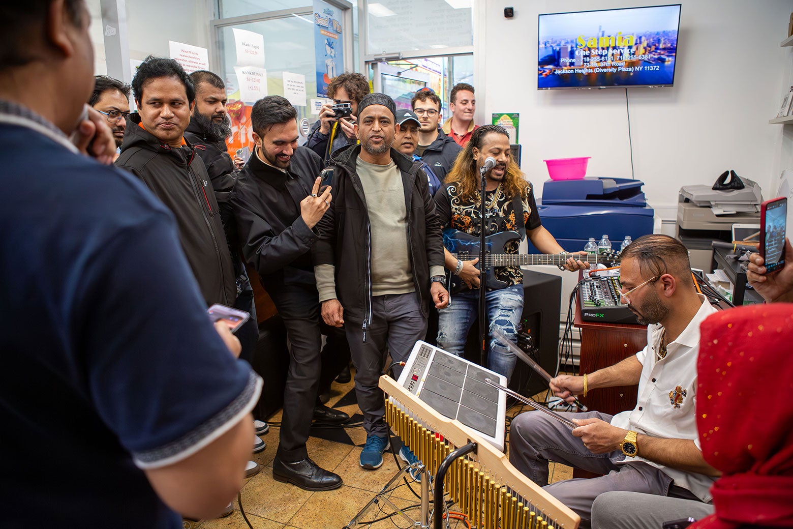 A crowd gathers around a musical act.