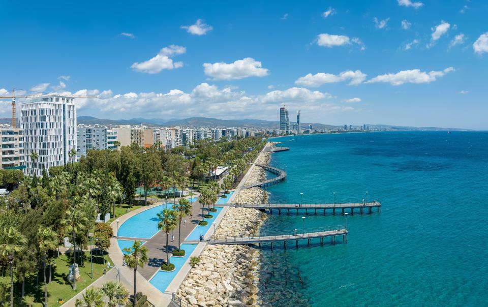 Aerial view of Limassol, Cyprus, showing the coastline, city buildings, and a park.
