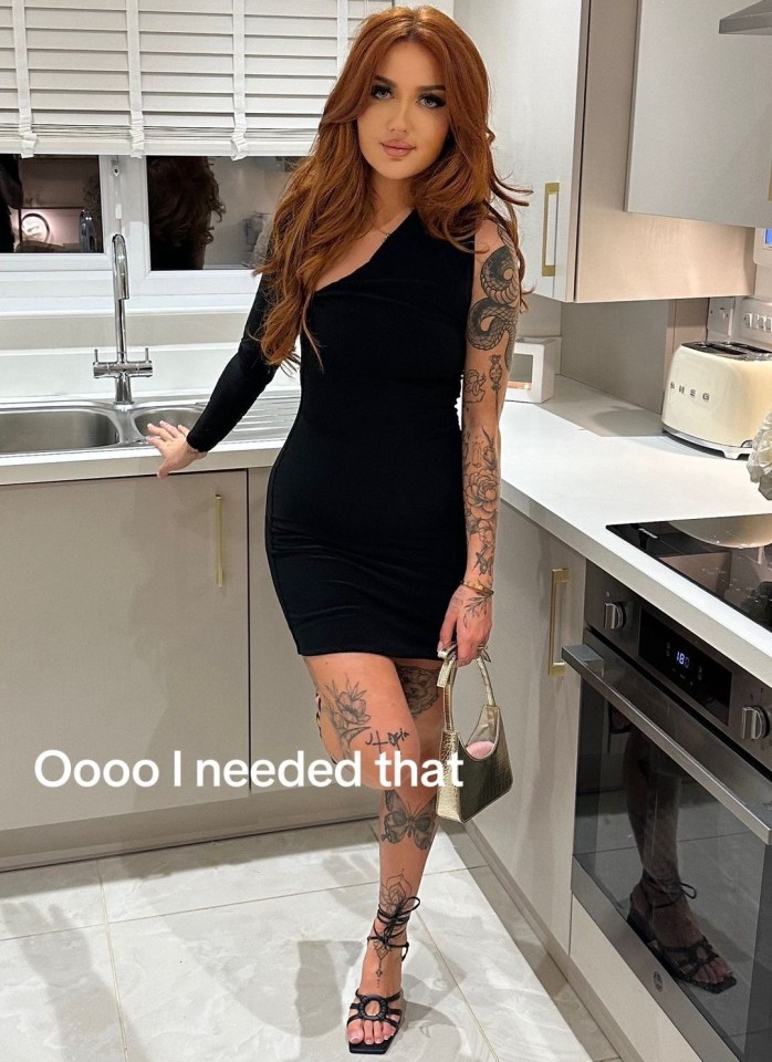 Woman in black dress and heels in a kitchen.