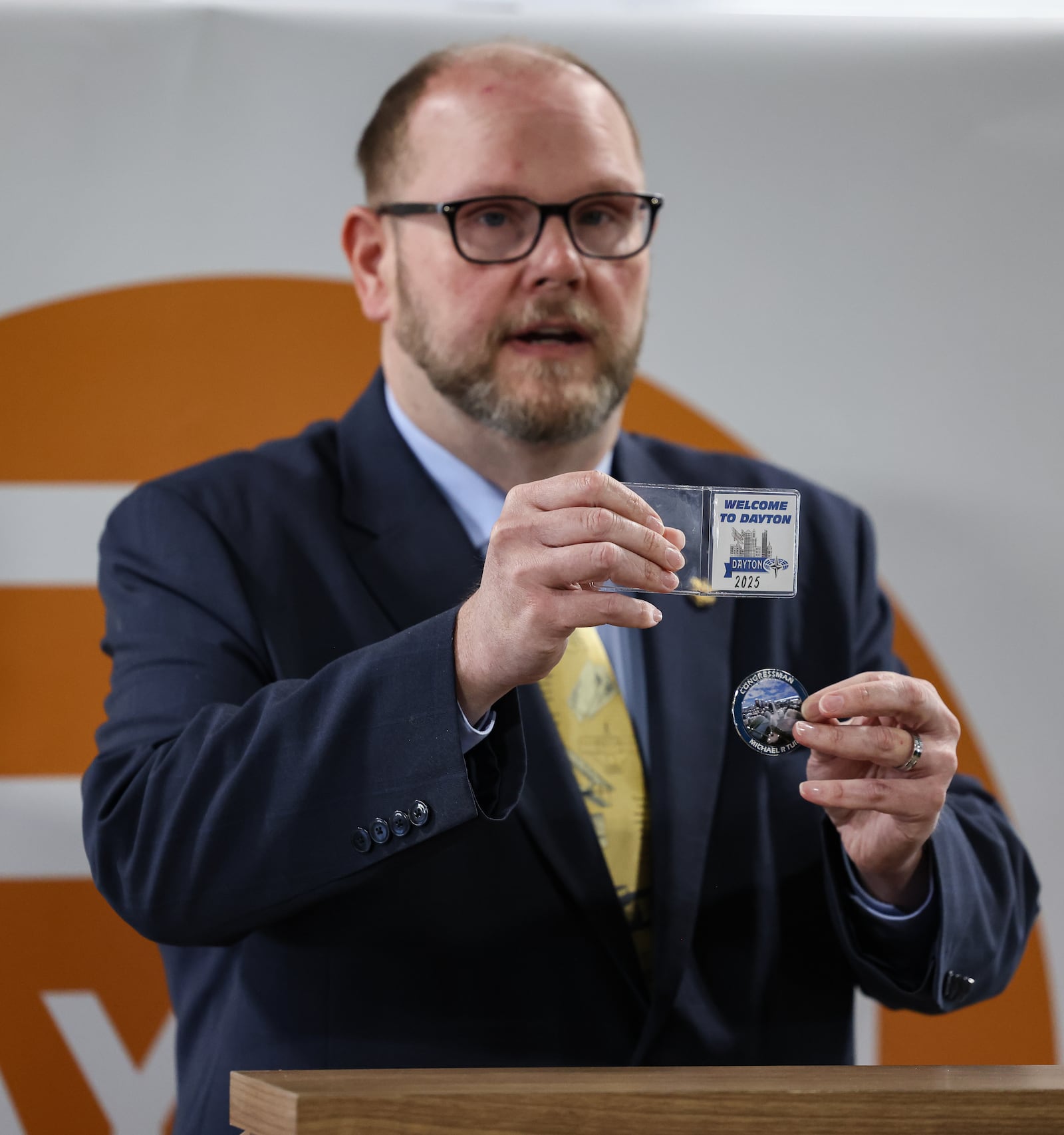 Hero Coins LLC CEO Andrew McKenna shows a coin he designed with input from Congressman Mike Turner's office that will be given to NATO Parliamentary Assembly Spring Session participants in May. BRYANT BILLING / STAFF