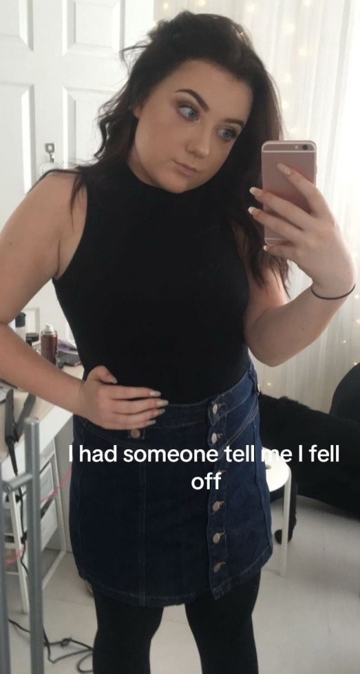 Selfie of a young woman in a black top and denim skirt.
