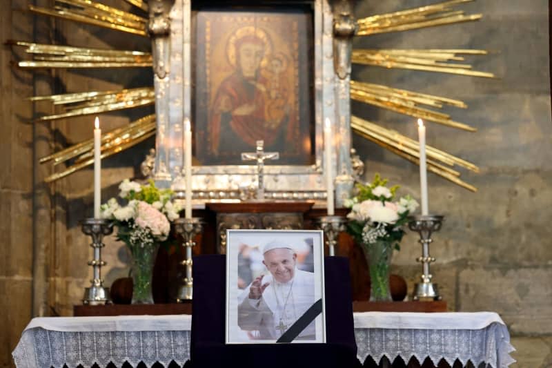 A picture of Pope Francis is displayed inside St. Stephen's Cathedral in Vienna, where people gather to attend a mass following the announcement of his death. The Argentine pontiff, who led the Catholic Church since 2013, passed away on April 21, 2025, at the age of 88, leaving a lasting legacy among millions of faithful around the world. Tobias Steinmaurer/APA/dpa