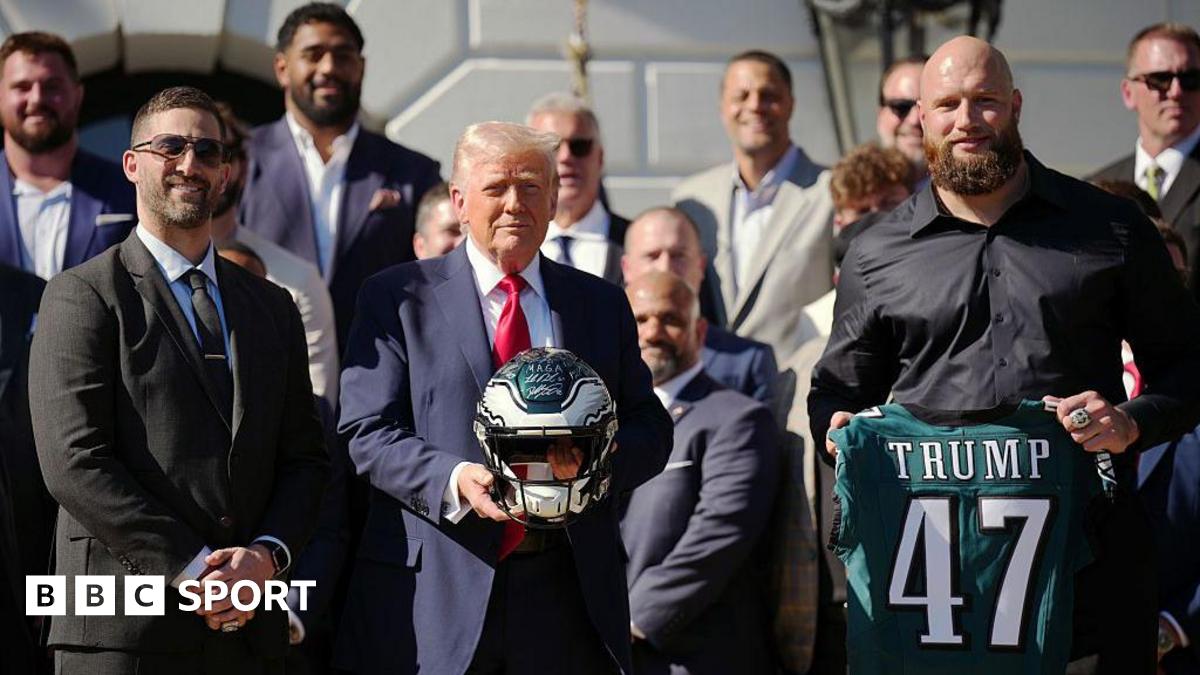 US President Donald Trump holds a helmet as he poses with Philadelphia Eagles head coach Nick Sirianni and offensive tackle Lane Johnson at an event welcoming the 2025 Super Bowl Champion Philadelphia Eagles on the South Lawn of the White House