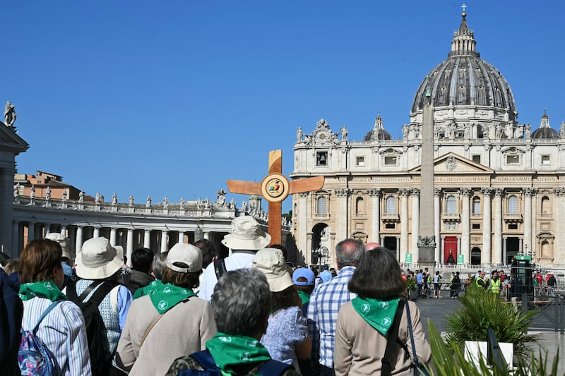 Pilgrims follow a cross outside St Peter's basilica in Rome on Tuesday. Photo: Getty Images