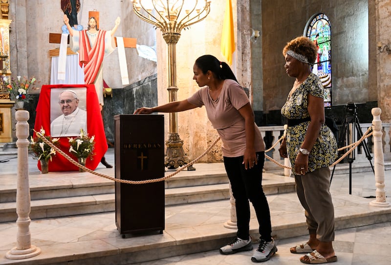 People line up to give an offering next to a picture of the late Pope Francis at the Caridad del Cobre church in Havana in Cuba on Monday. Photo: Getty Images