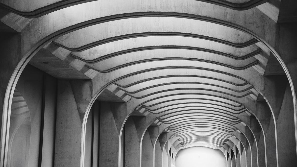 A black and white photo of a modern corridor