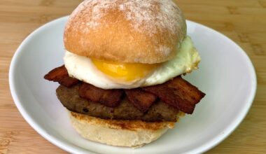 Toasted roll with steak square, smoked bacon and egg