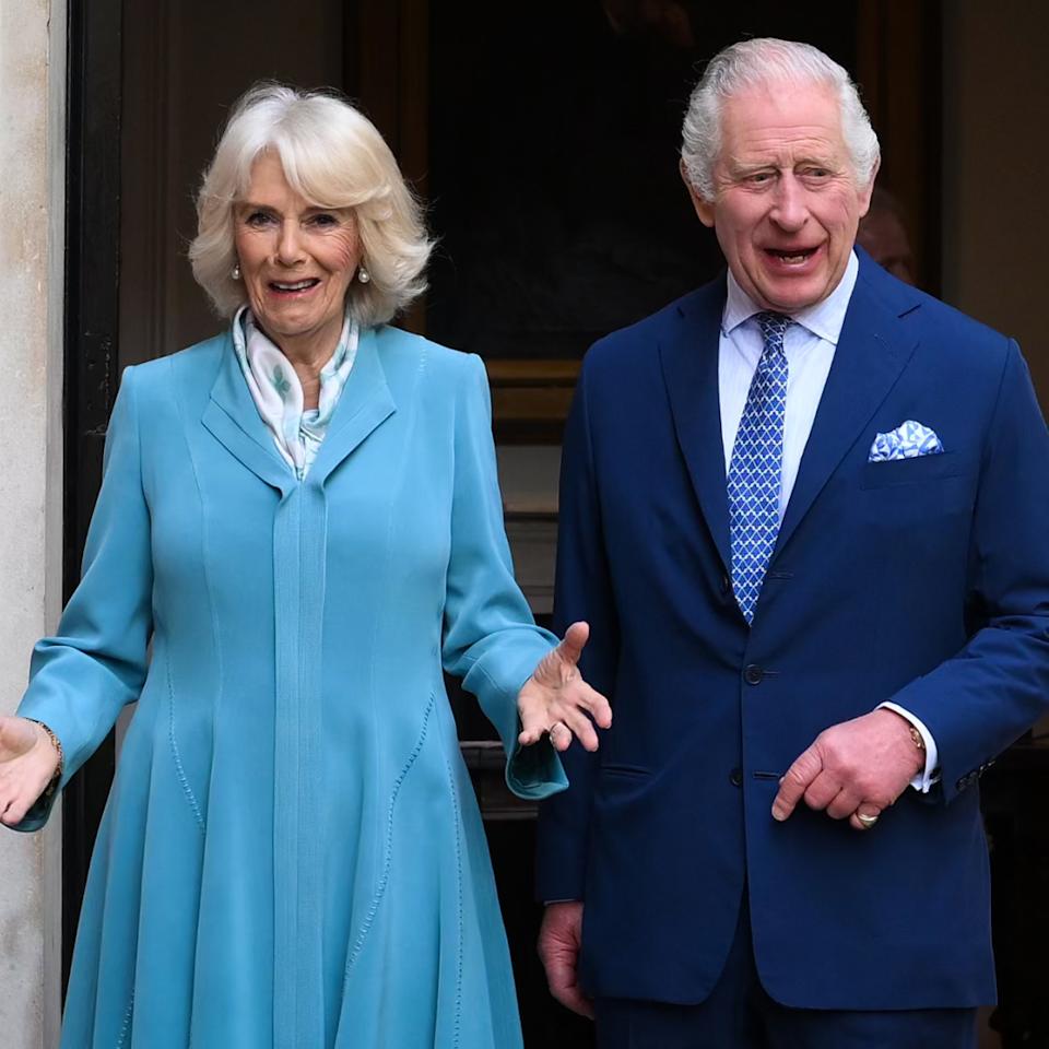  Queen Camilla wears a turquoise dress and King Charles wears a blue suit. 